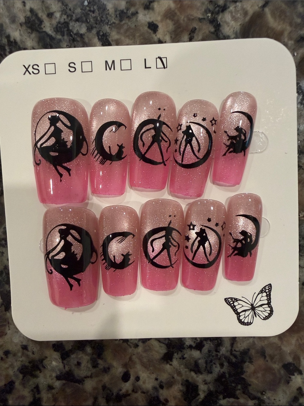 Pink cateye French tip with black sailor moon accents acrylic press on nail